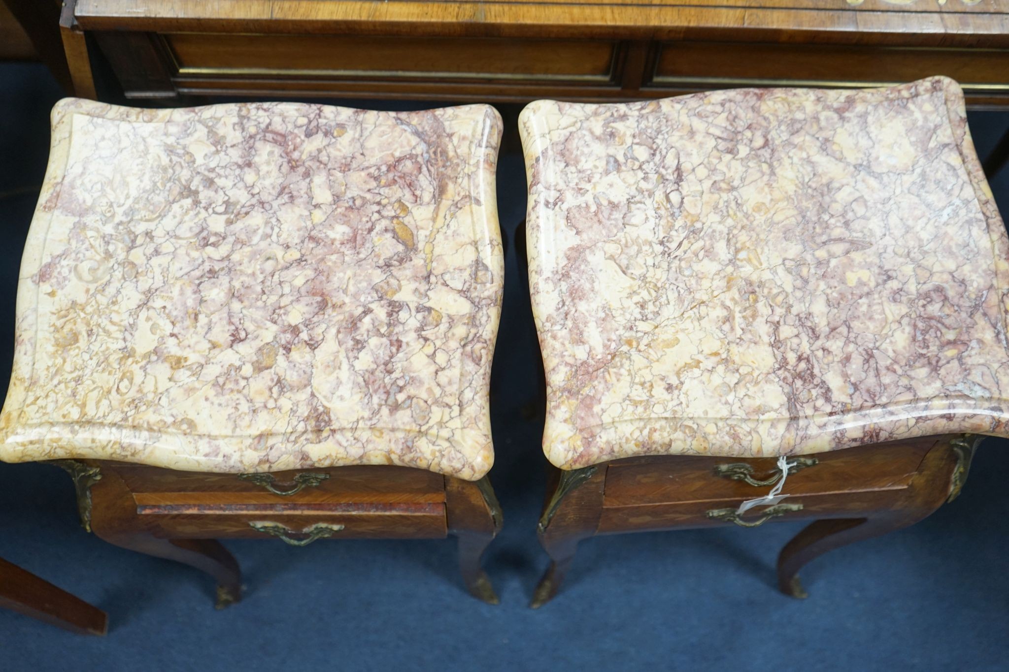 A pair of Louis XVI design marquetry inlaid, gilt metal mounted serpentine bedside chests, width 34cm, depth 29cm, height 73cm